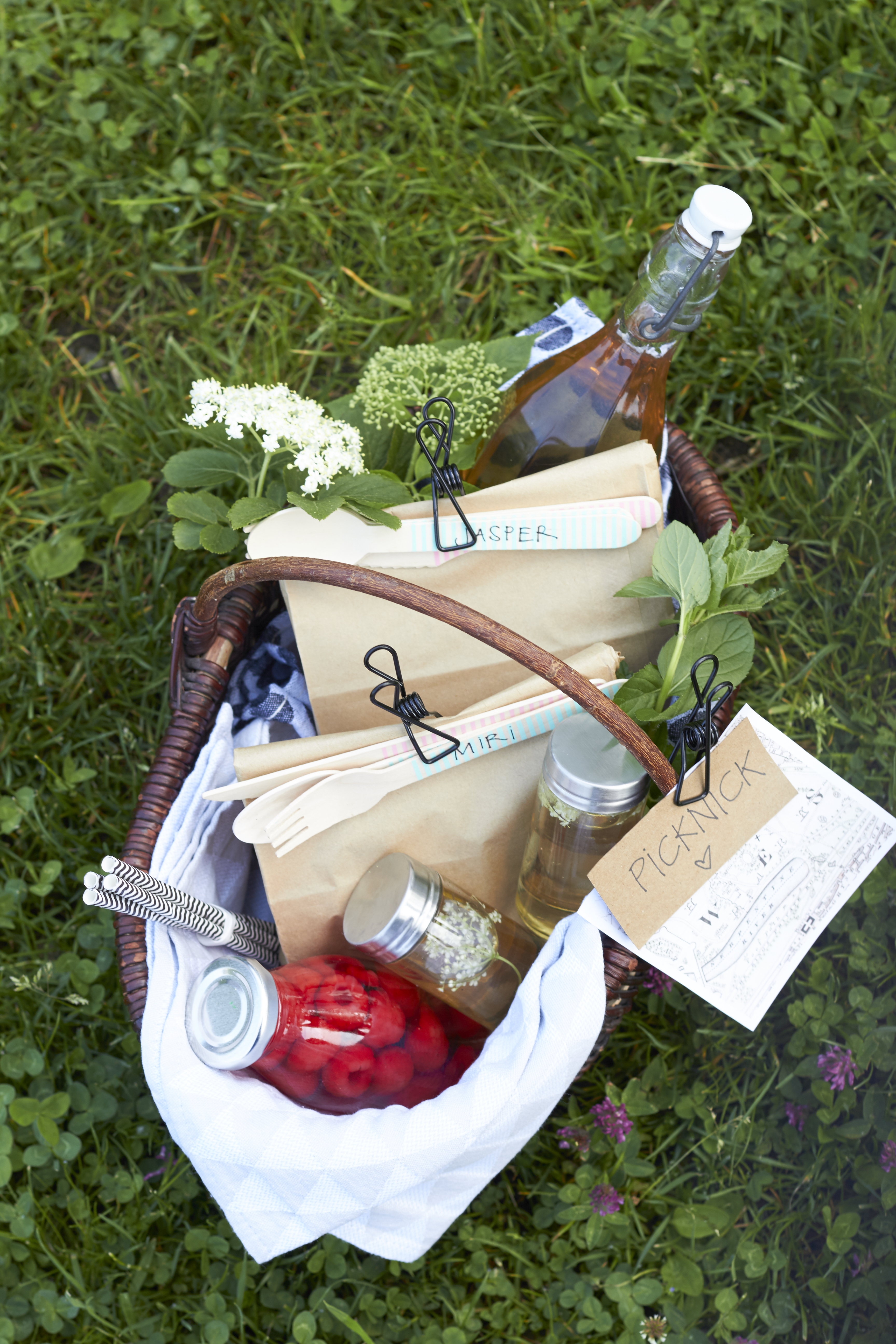 ein gepackter Picknick-Korb mit Holunderblütenlikör für den